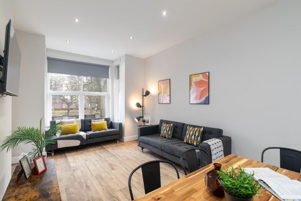 Bright and welcoming living room featuring larg...