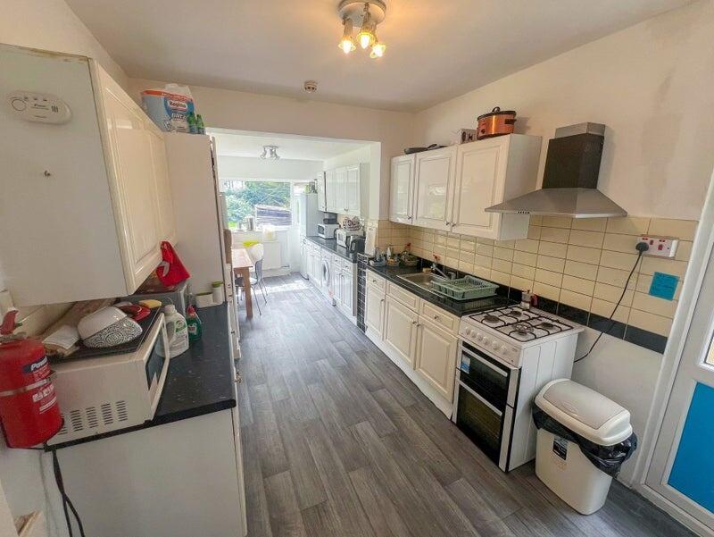 A bright and well-equipped kitchen with modern ...