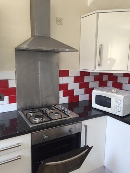 A modern kitchen area featuring a gas stove, mi...