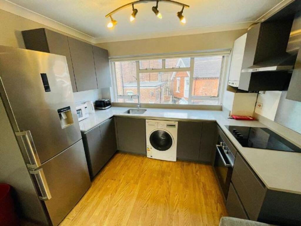 A modern and spacious kitchen featuring ample s...