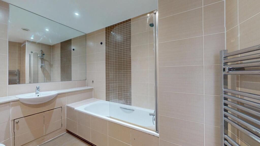 A modern and pristine bathroom featuring a spac...