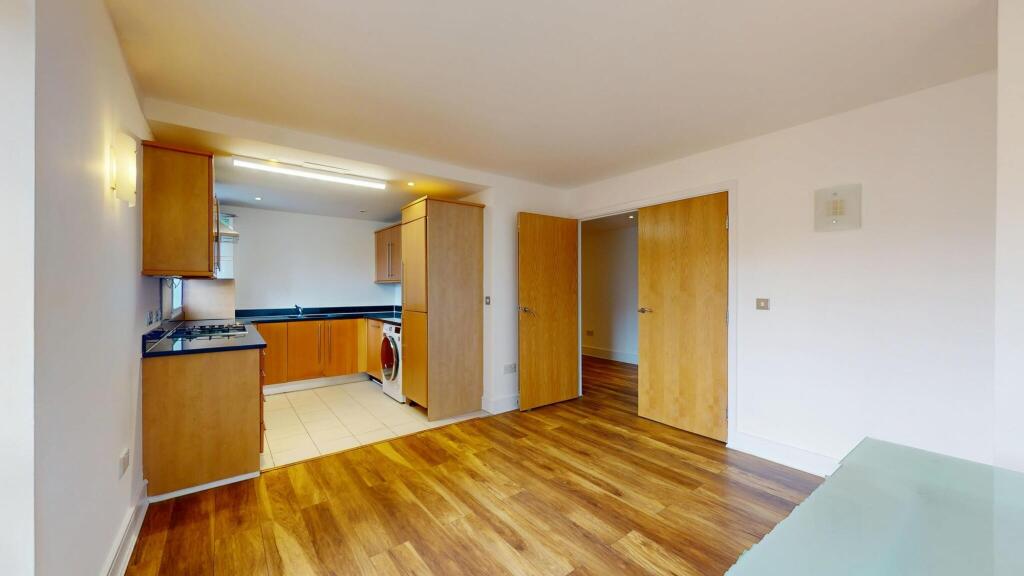 Modern kitchen area with wooden cabinets and bl...