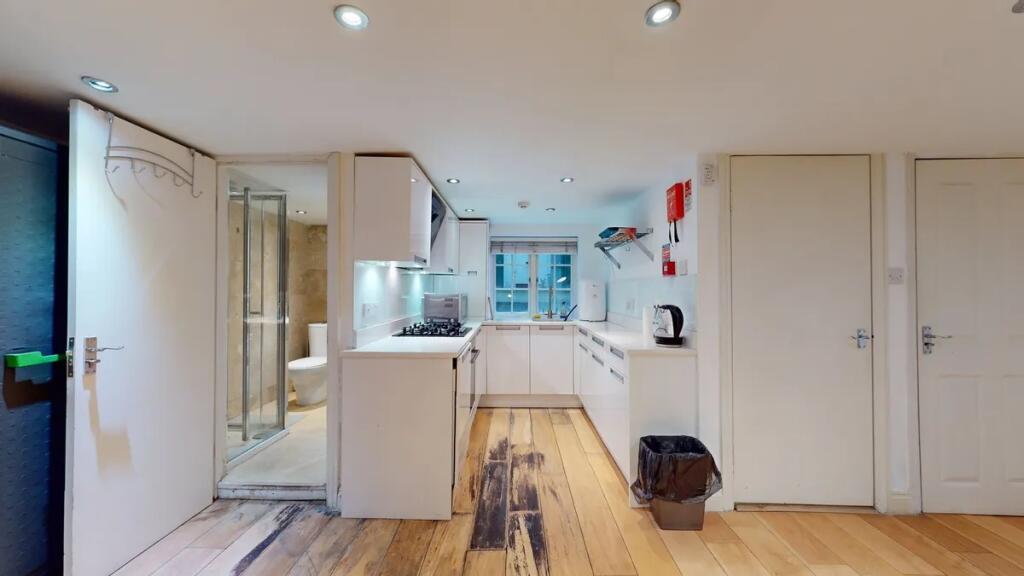 Bright and modern kitchen with sleek white cabi...