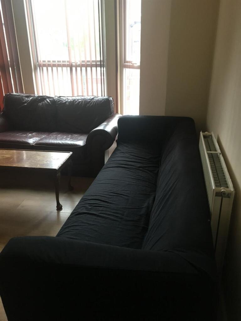 Bright ground-floor living room with large wind...