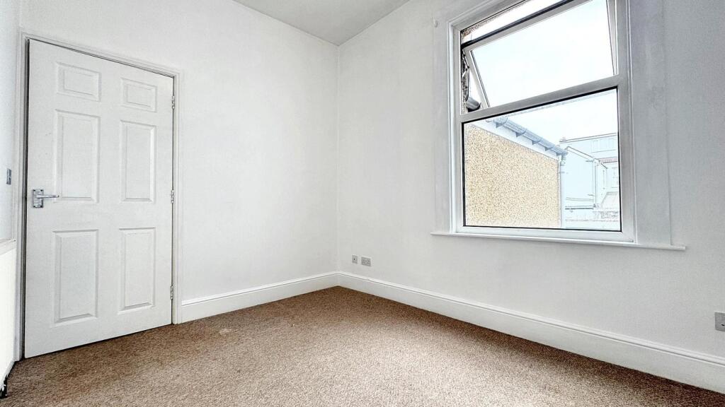 This inviting double bedroom features a large w...