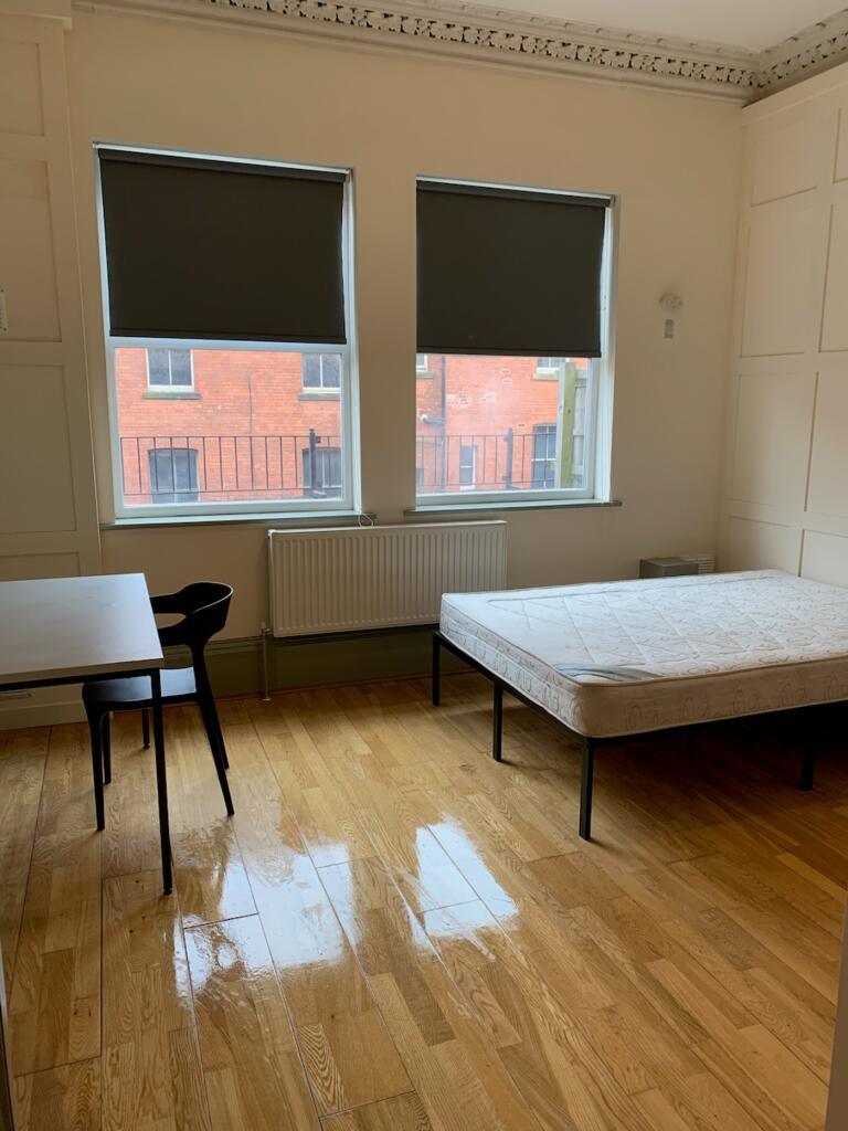 A spacious and bright double bedroom featuring ...