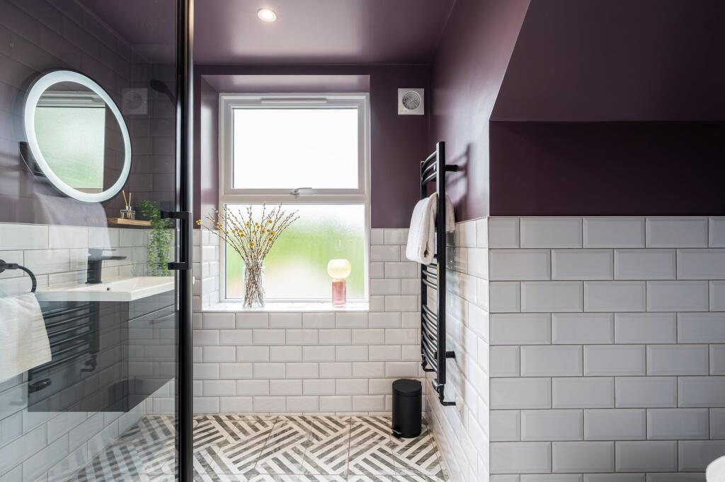Modern bathroom featuring a large frosted windo...