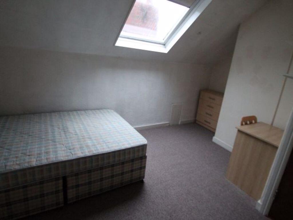 A simple, quiet double bedroom featuring a larg...
