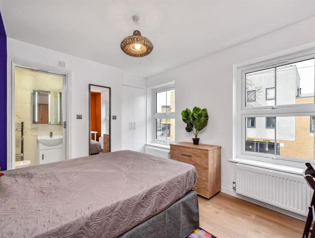 Bright and well-maintained bedroom with two lar...
