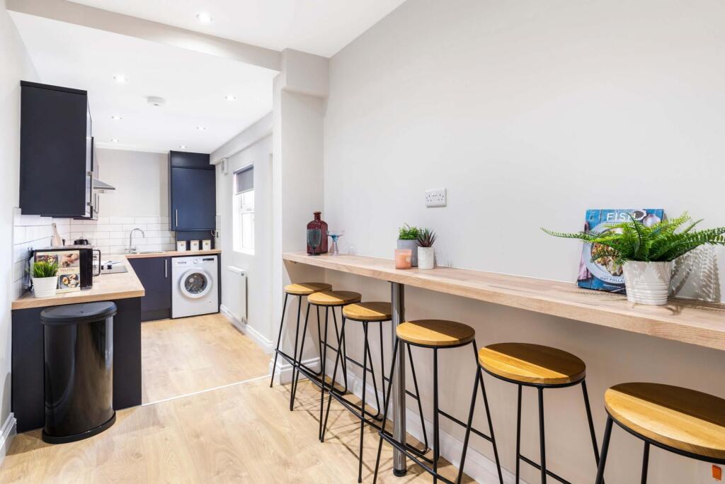 Bright modern kitchen with a breakfast bar and ...