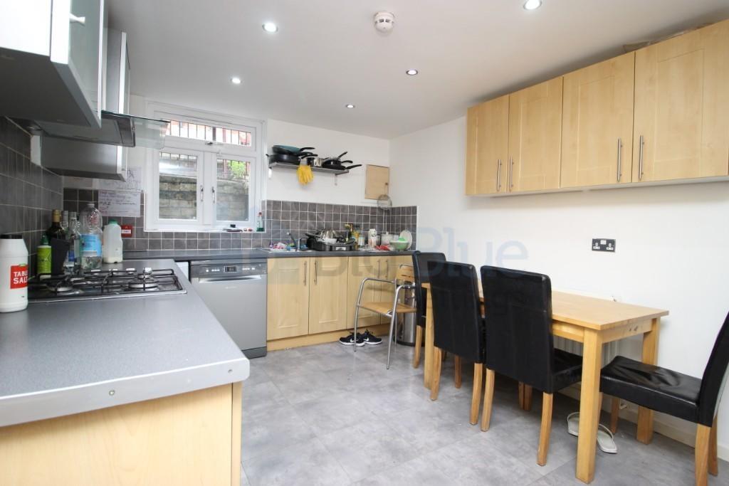 Bright and modern kitchen featuring light wood ...