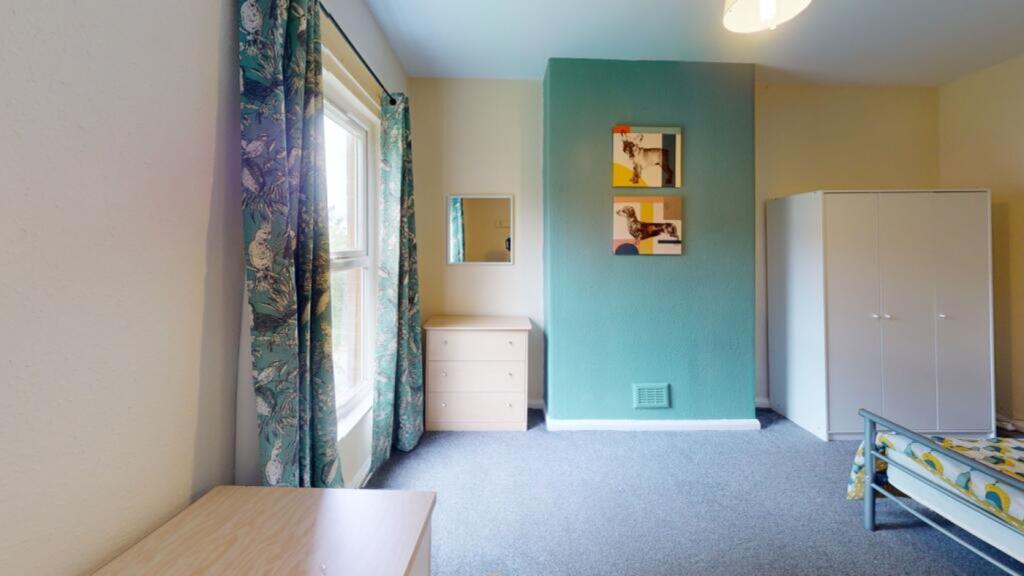 A bright and inviting double bedroom with ample...