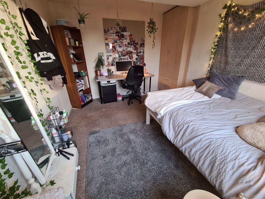 A bright and cozy master bedroom featuring a co...