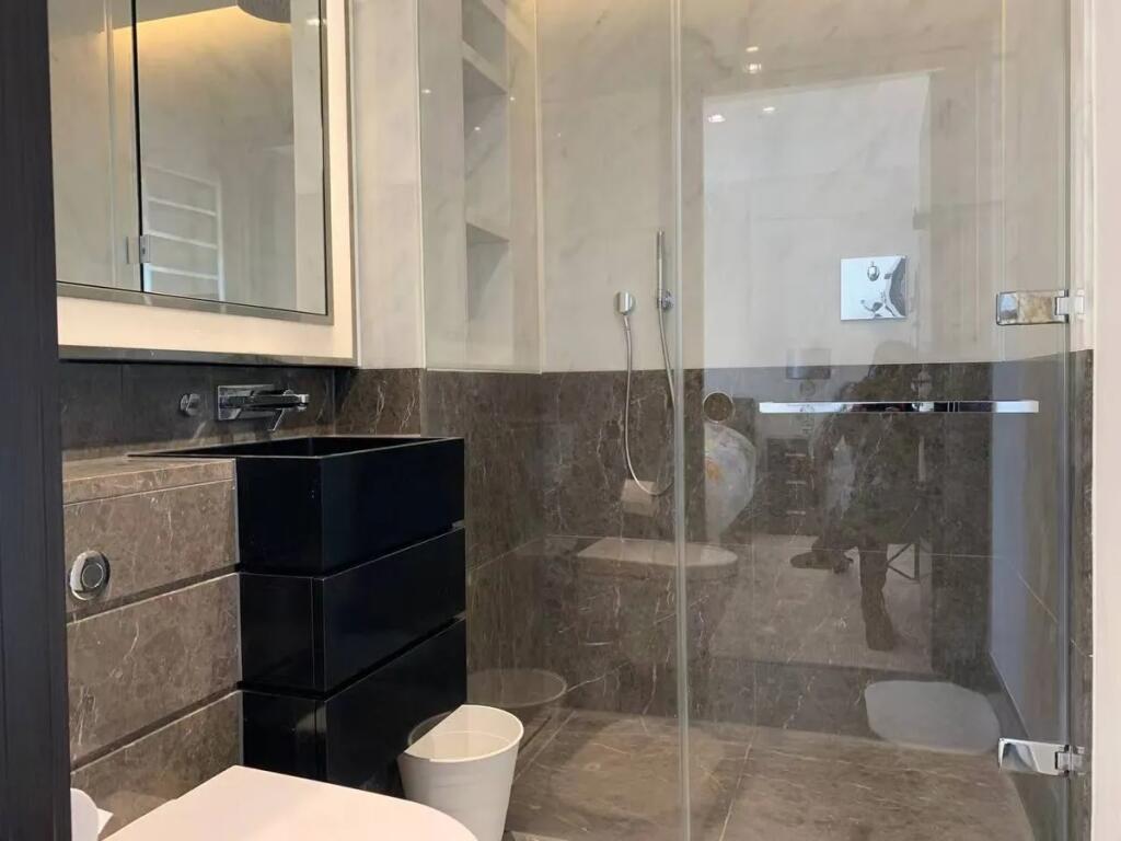 A modern bathroom suite featuring elegant marbl...