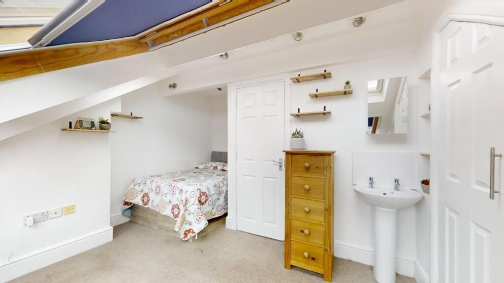 Bright and spacious master bedroom with a comfo...