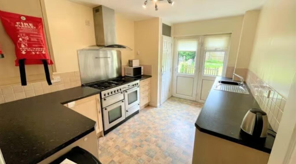 Bright and well-equipped kitchen featuring ampl...