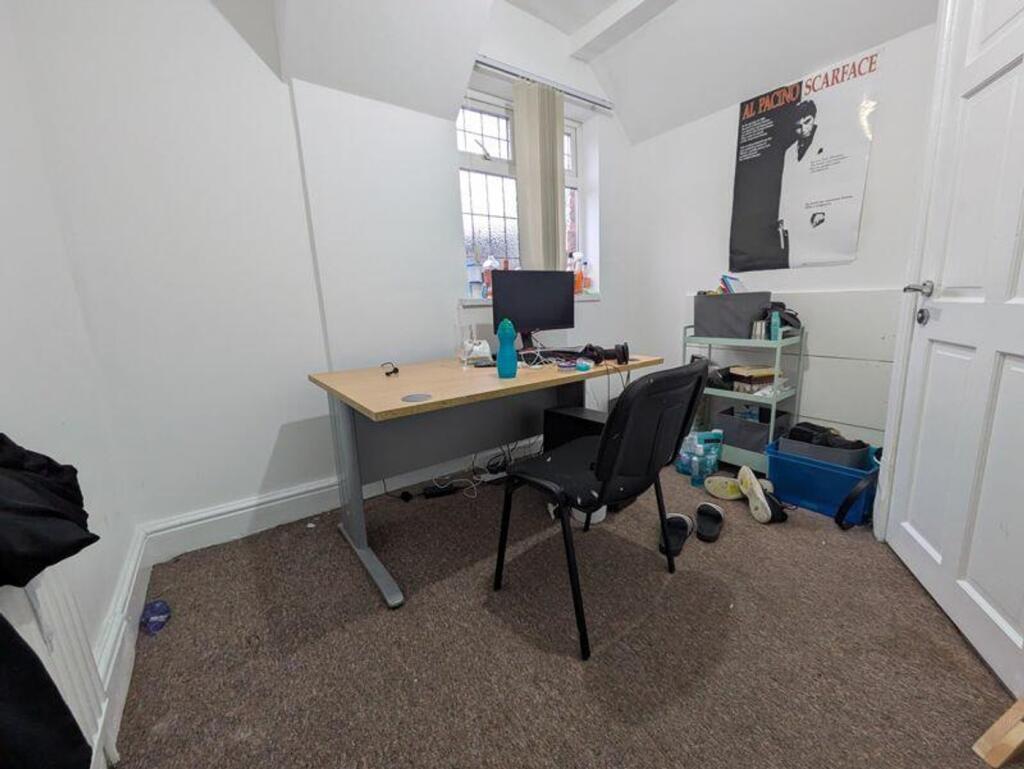 A workspace with ample natural light, featuring...