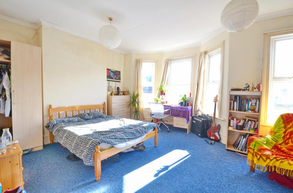 Bright and spacious master bedroom featuring a ...