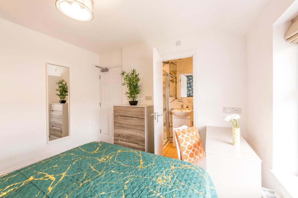 A bright and inviting double bedroom featuring ...