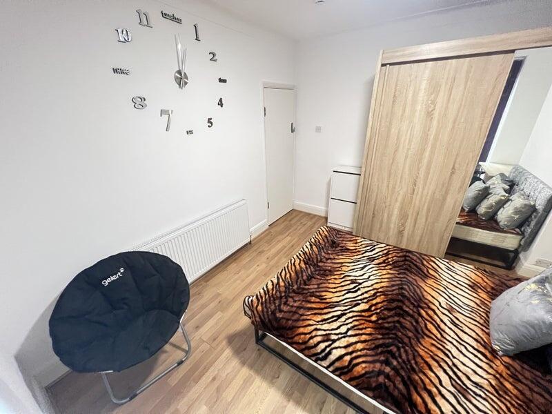 Cozy double bedroom featuring a stylish tiger-s...