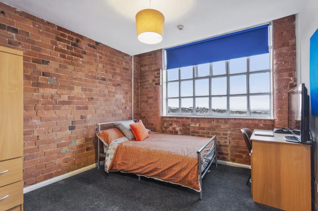 A stylish and well-lit double bedroom featuring...