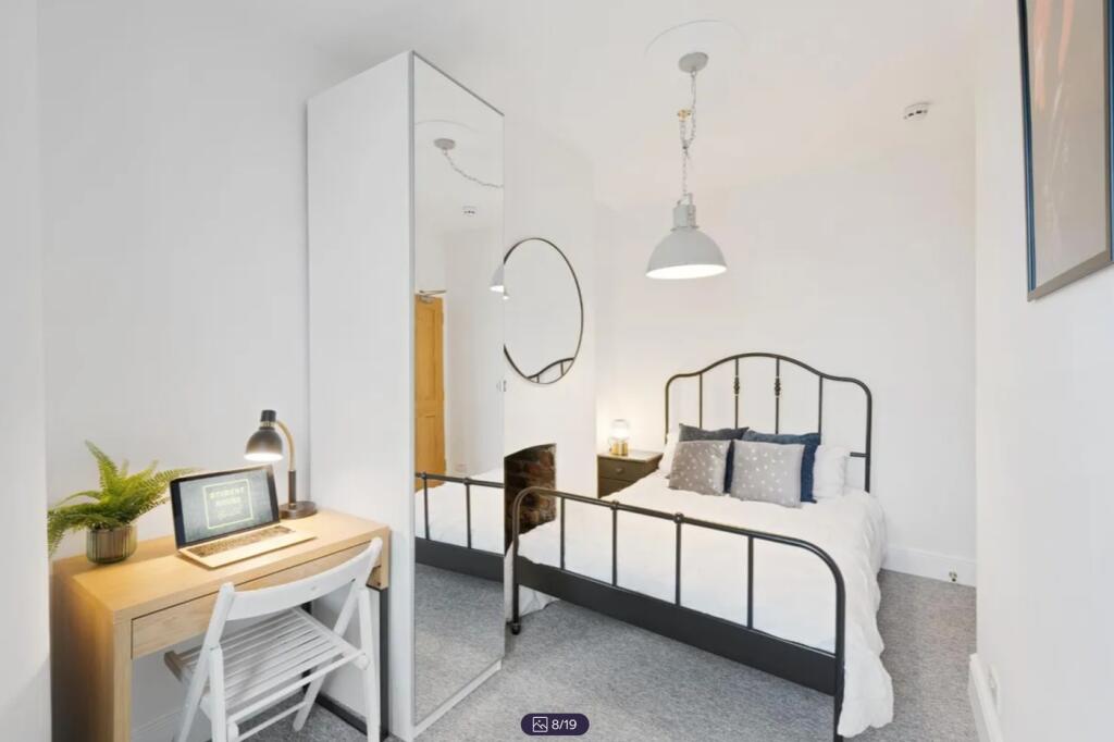 A bright and stylish double bedroom featuring m...