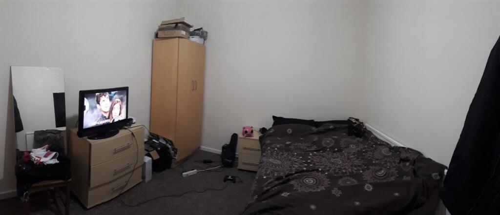 Cozy furnished bedroom with a double bed, wardr...