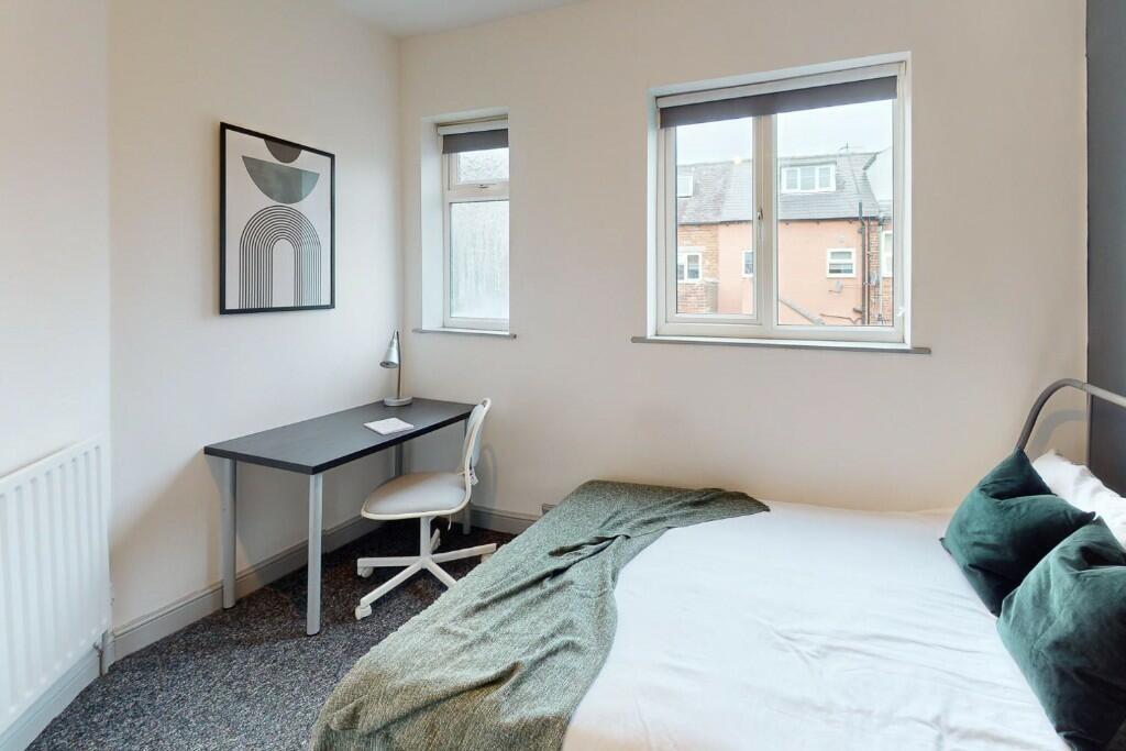 A bright and tidy single bedroom featuring a co...