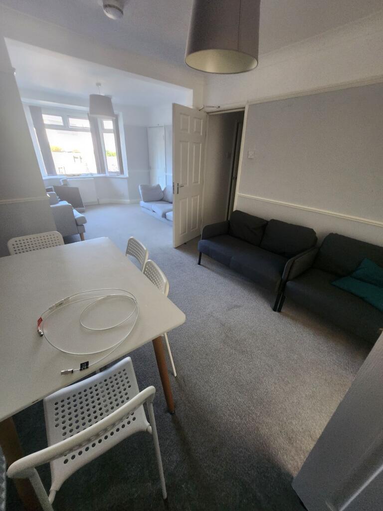 A bright and spacious living room featuring lar...