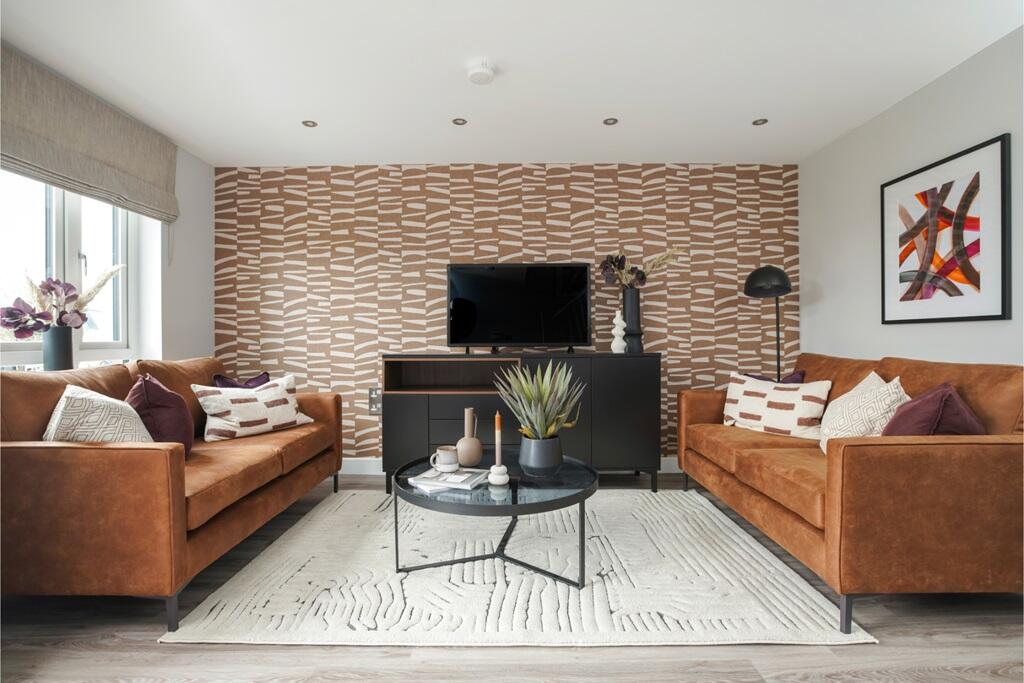 A spacious and inviting lounge with large windows that allow plenty of natural light to flood the r