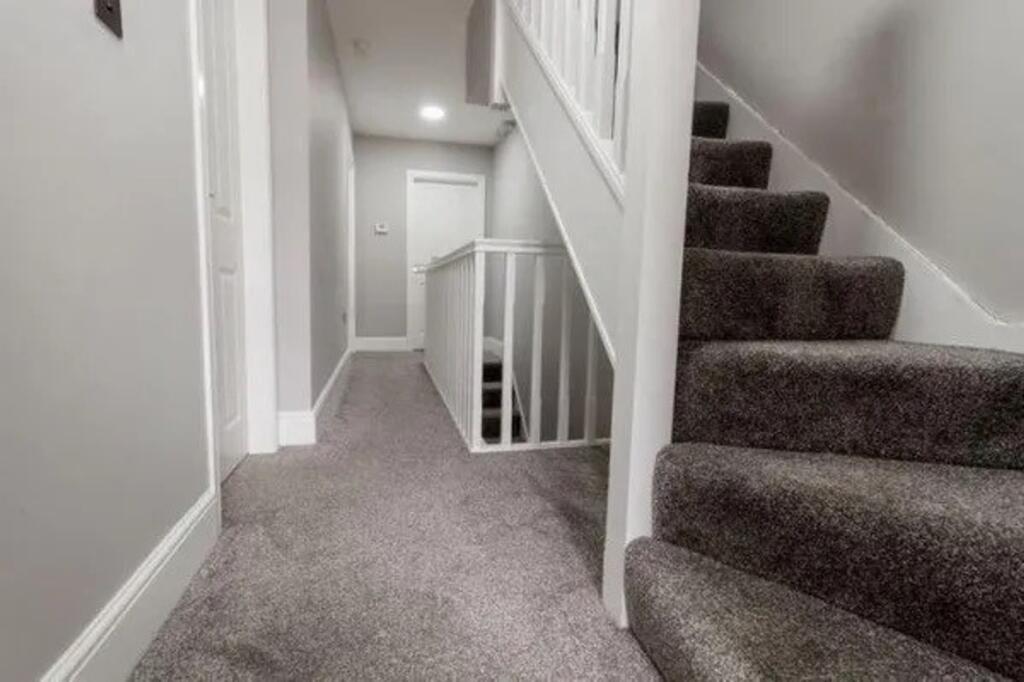 A clean and well-maintained hallway with modern...