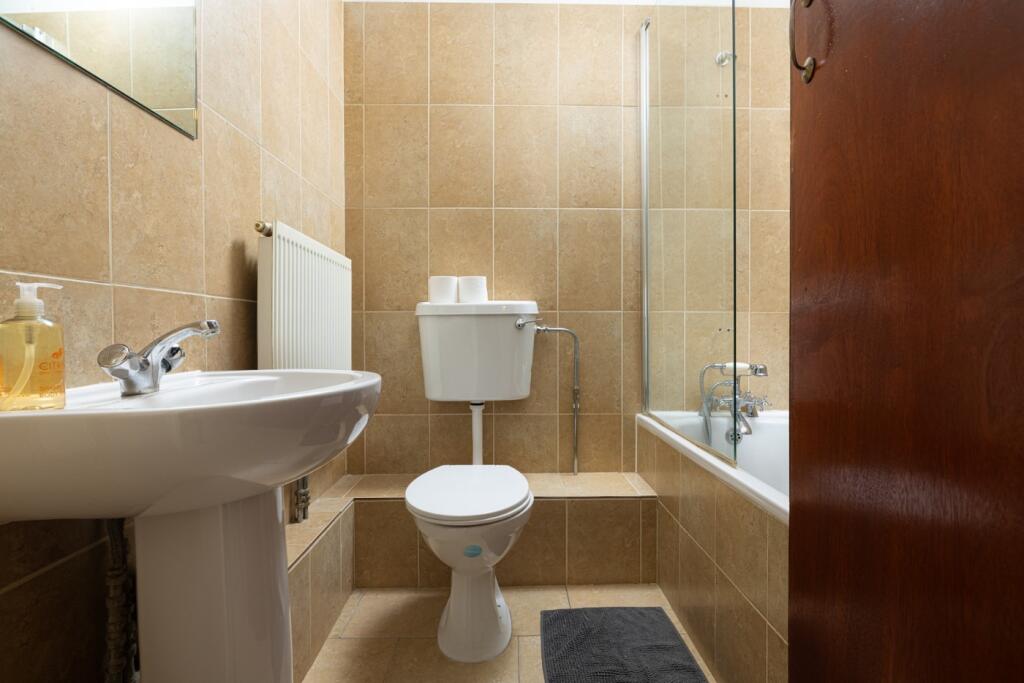 A clean and well-maintained bathroom featuring ...