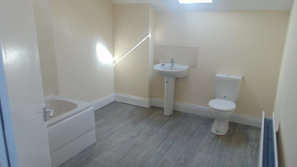 Bright and spacious bathroom suite featuring a ...