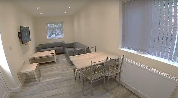 A bright and welcoming living room featuring am...