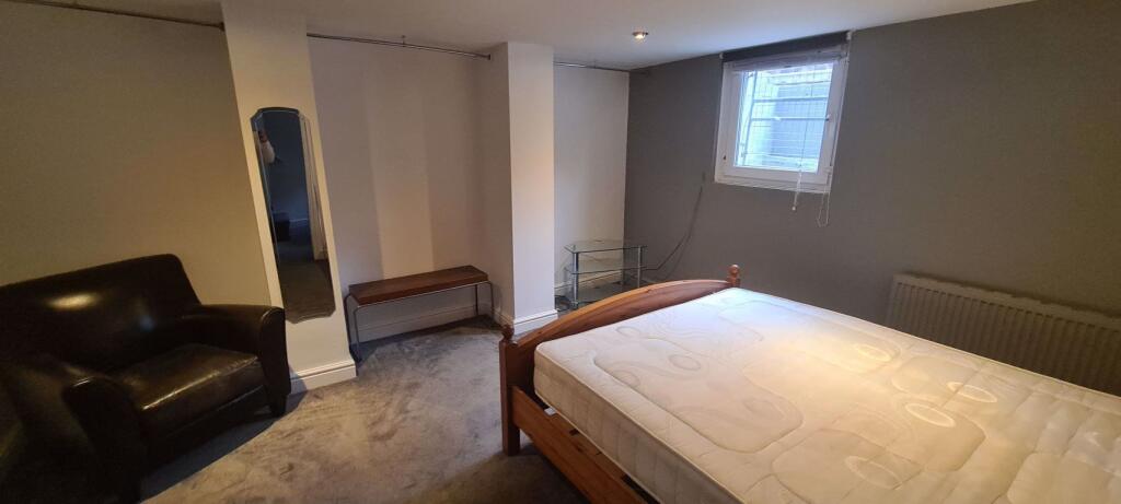 A cozy double bedroom featuring a comfortable w...