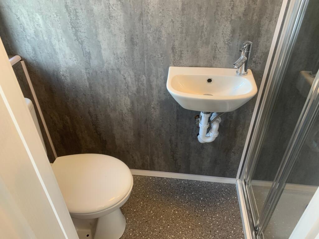 A modern bathroom featuring a sleek shower and ...