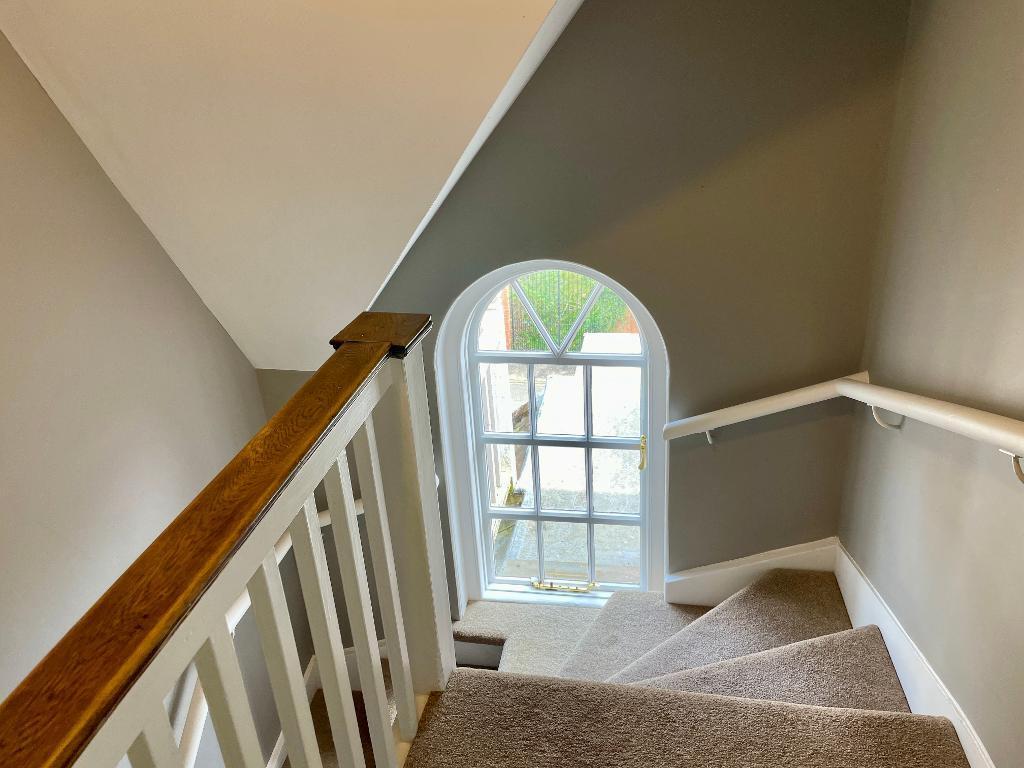 Sunlight filled staircase to bedrooms