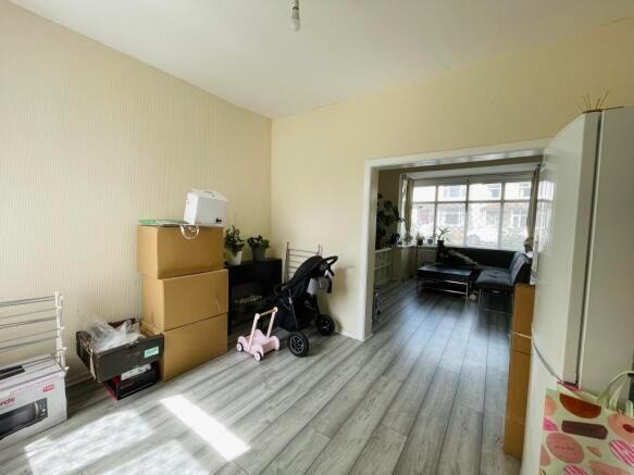 A bright living room with light wooden flooring...