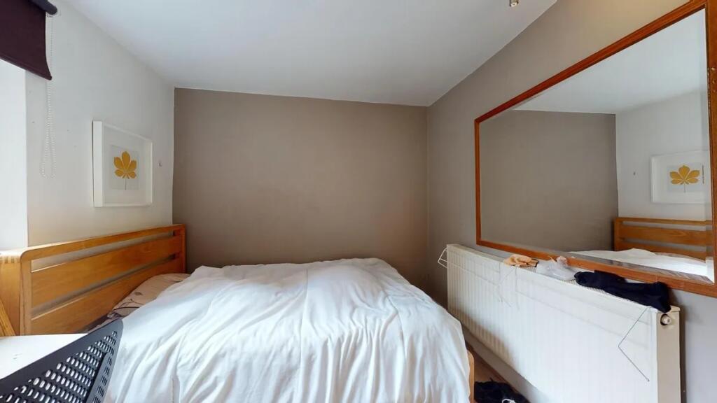 A cozy double bedroom featuring a comfortable w...