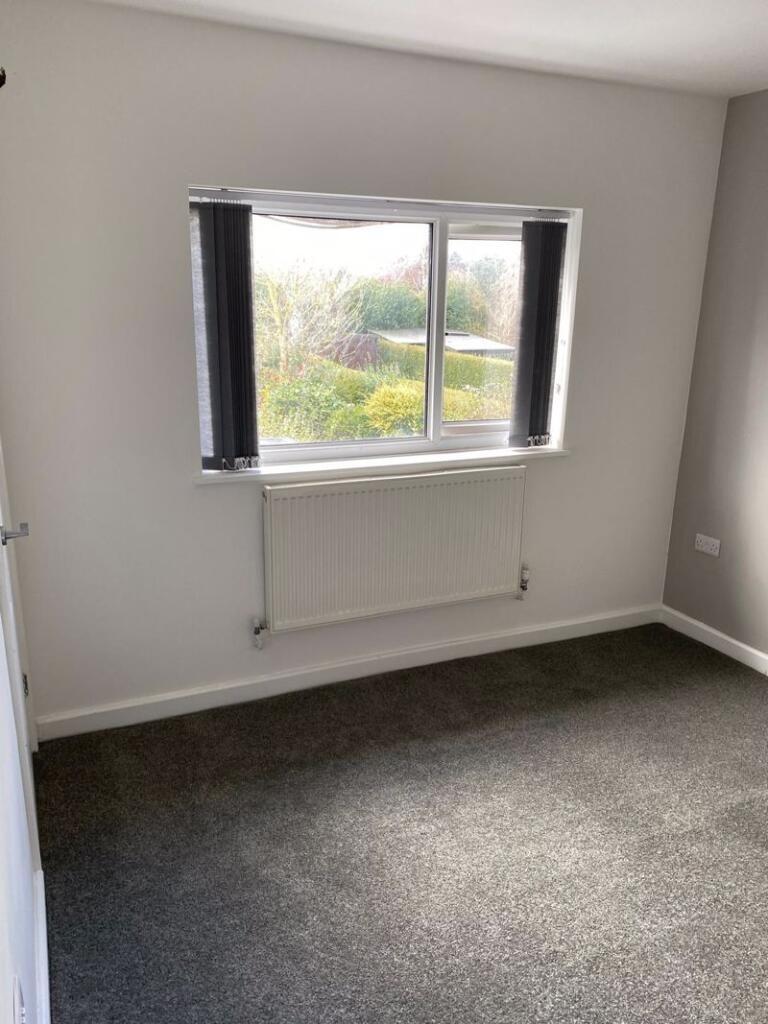 A bright and clean single bedroom featuring a l...