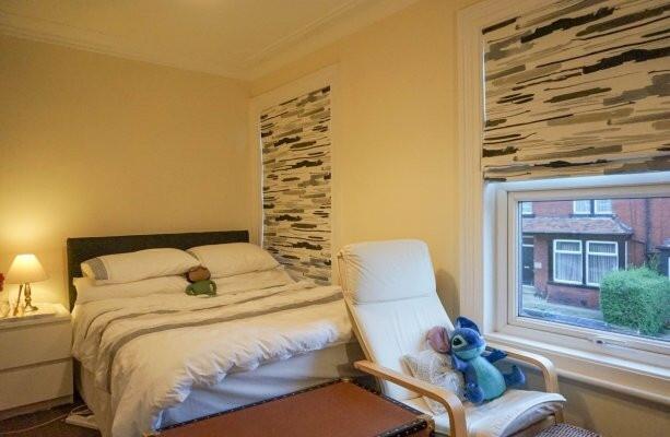 A cozy double bedroom featuring a comfortable b...