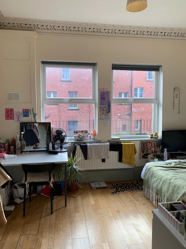 A bright and spacious double bedroom with large...