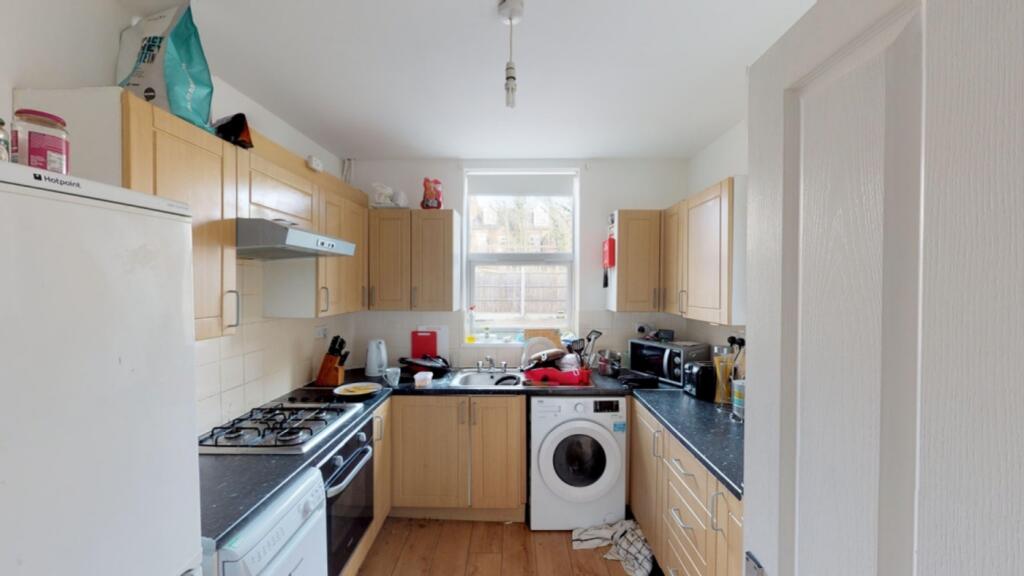 A spacious kitchen with ample storage and natur...