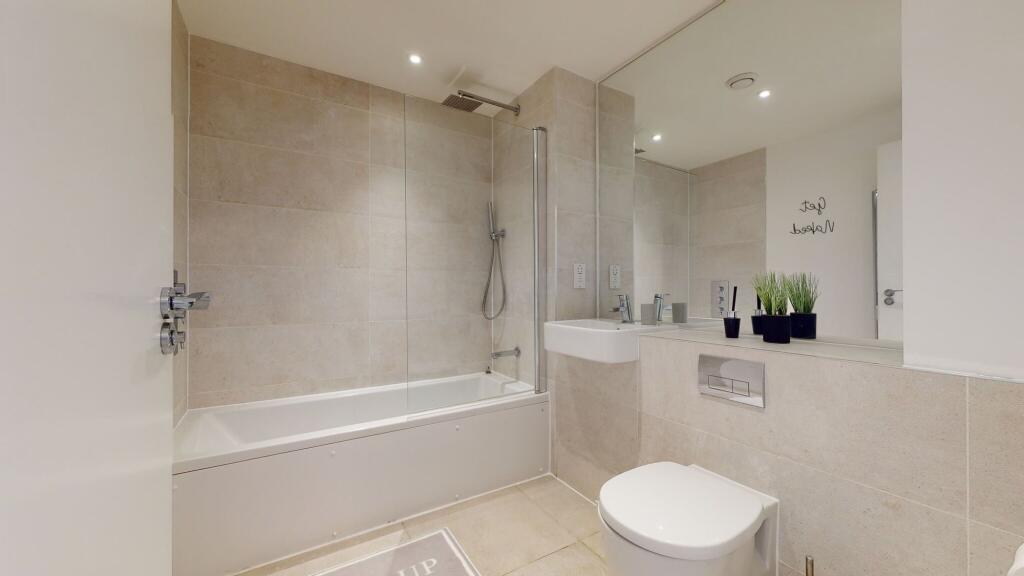 Bright and modern bathroom featuring a full bat...