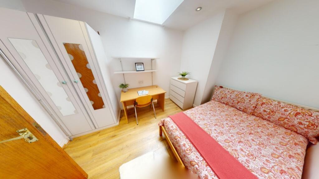A bright and inviting double bedroom featuring ...