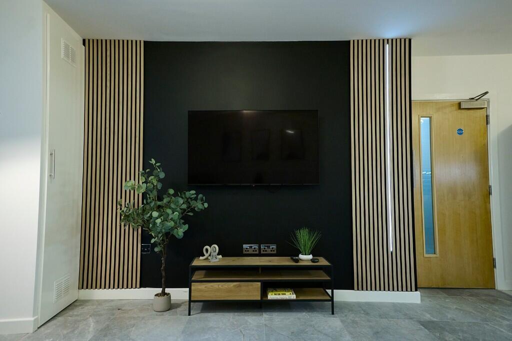 A modern living room featuring a sleek black ac...