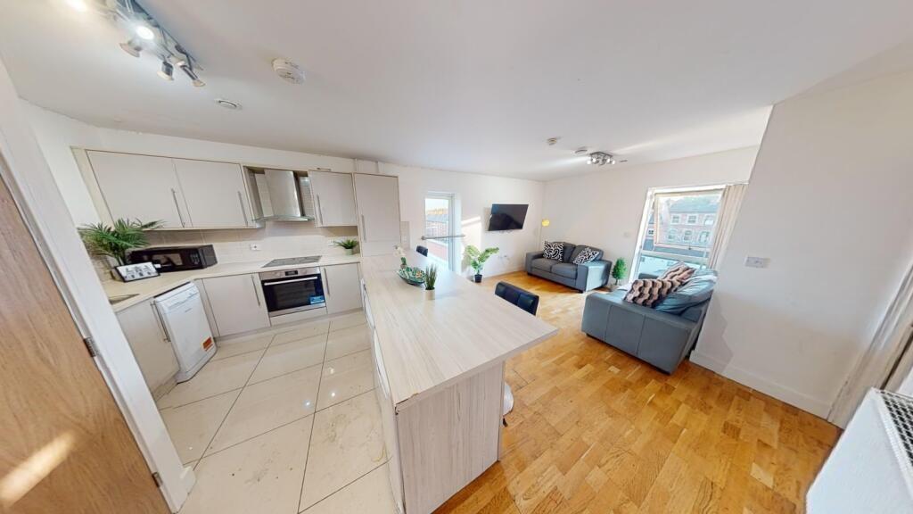 A bright and modern open-plan living area with ...