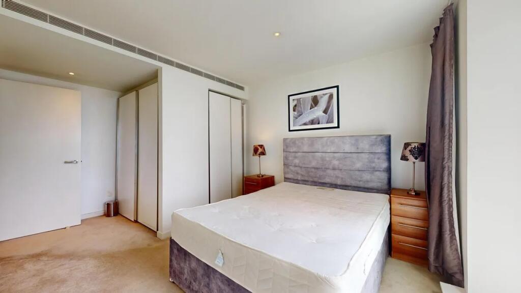 Bright and tidy double bedroom featuring a comf...