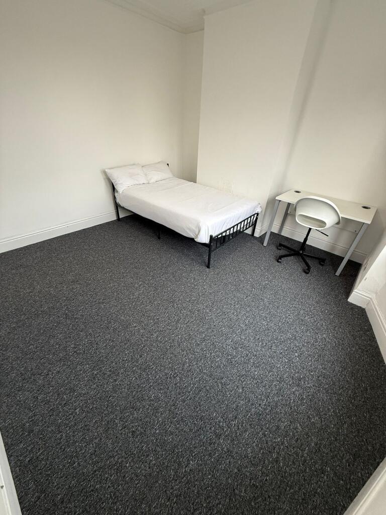 A bright and inviting double bedroom featuring ...