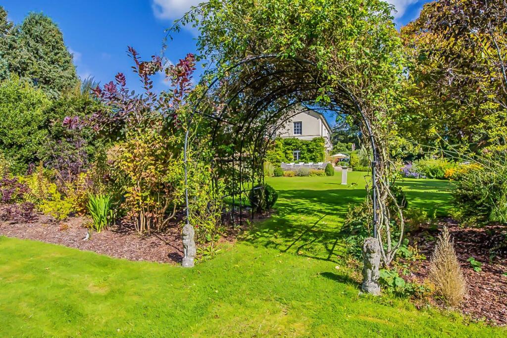 Garden arch framing views of the manor